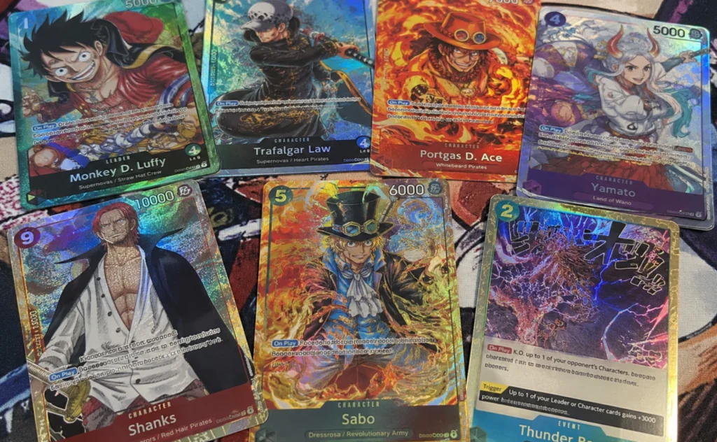 one piece tgc singles , A spread of holographic One Piece TCG cards including Monkey D. Luffy, Shanks, Portgas D. Ace, and Sabo pulled from a booster pack